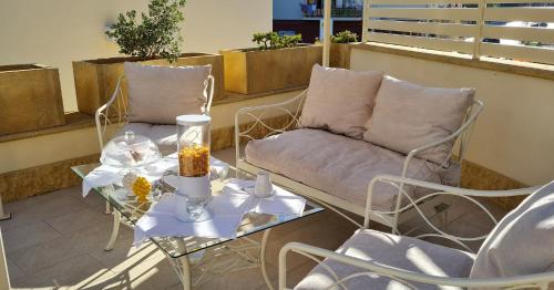 a balcony with a couch and a table and chairs at ‘A Minnula in San Cataldo