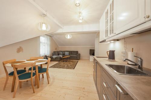 a kitchen and living room with a table and chairs at Tõnisson Apartments in Tartu