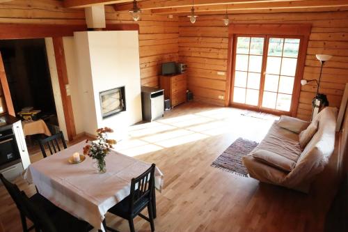 a living room with a table and a couch at Holiday house with sauna in Rīga