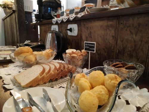 a buffet of bread and pastries on a table at Casa do Chá Ouro Preto in Ouro Preto