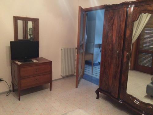 a living room with a tv and a wooden dresser at Casa Prunilla in Sarno