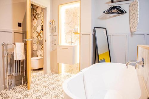 a bathroom with a sink and a tub in a room at The Jacobean Hotel in Coventry