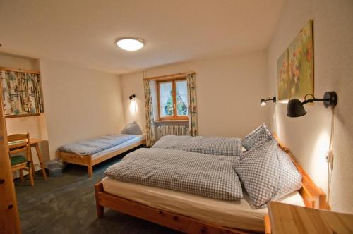 a bedroom with a bed and a window at Dent Blanche in Zermatt