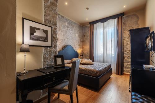 Un ou plusieurs lits dans un hébergement de l'établissement La Locanda Del Conte Mameli