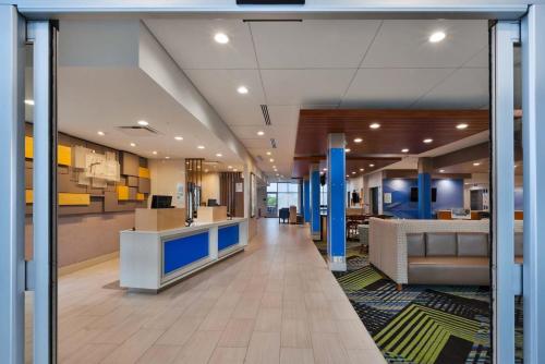 a lobby of a hospital with a waiting room at Holiday Inn Express & Suites - Grand Rapids Airport - South by IHG in Grand Rapids
