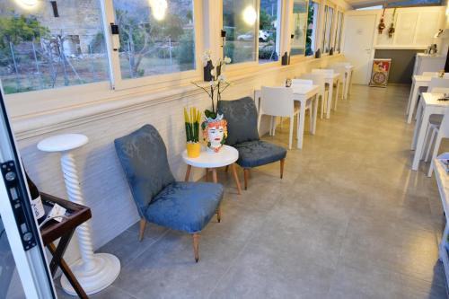 a dining room with chairs and a table in a restaurant at Inkantu B&B in Terrasini
