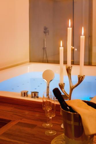 a bathroom with a tub with candles and a candle holder at Naca Suite in Catania