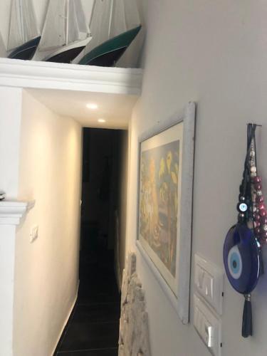 a hallway with a staircase and a painting on a wall at Villa Francesca - Manfredi Homes&Villas in Monte SantʼAngelo