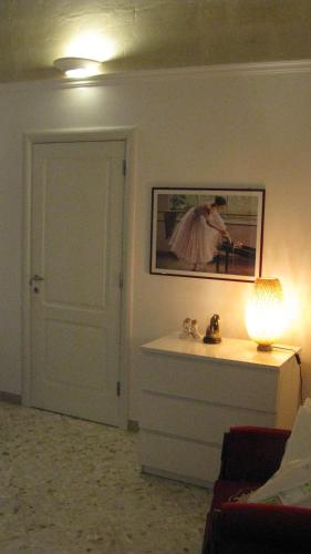 a room with a door and a picture of a woman at Casa Vacanze Patrizia in Montescaglioso