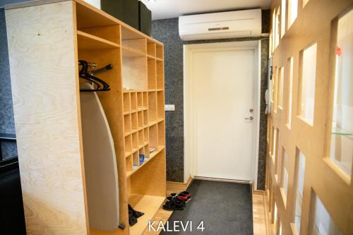 a room with a closet with a door and a shelf at City Center Turu str apartments, parking, Tartu Home in Tartu