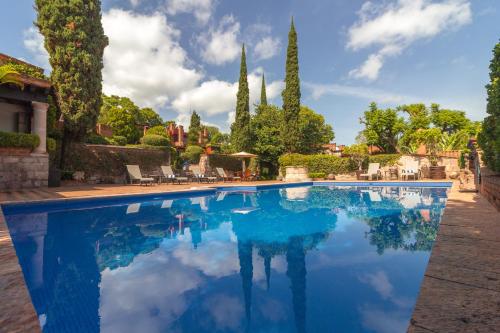 a swimming pool in a villa with trees at Villa Montaña Hotel & Spa in Morelia