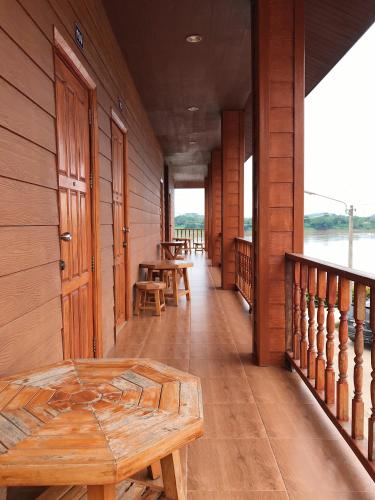 a room with tables and benches on a building at คอมคิม ริมโขง เชียงคาน in Loei