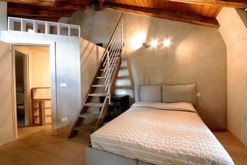 a bedroom with a bunk bed and a ladder at Vieille maison in Aosta