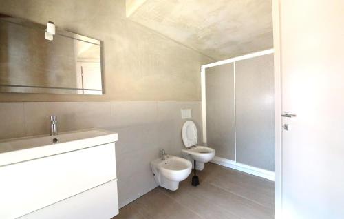 a bathroom with a toilet and a sink and a shower at Vieille maison in Aosta