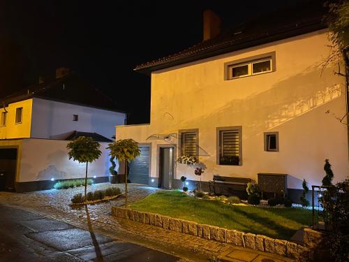 a large white house at night at Apartamenty pod Wieżą in Zgorzelec
