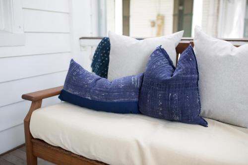 a group of blue pillows sitting on a bench at The Charlestonian in Charleston