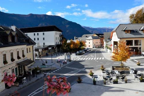 an empty street in a town with mountains in the background at Cozy Apartment Bovec in Bovec
