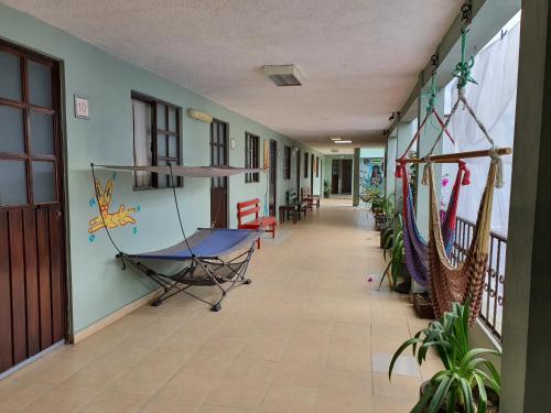 a hallway with a room with a ping pong table at Hierba De Conejo Hostel in Oaxaca City