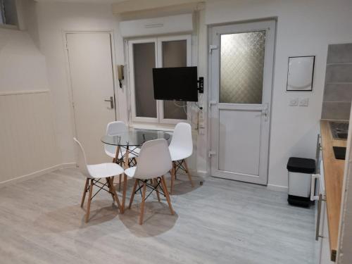 une salle à manger avec une table et des chaises blanches dans l'établissement Saint Etienne Studio Lot 1, à Toulouse