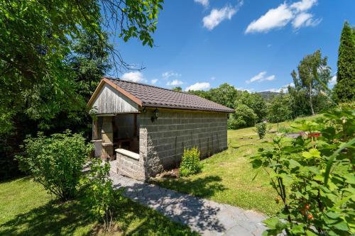 a small building in a yard with a grass field at Apartmány U Žaloudků in Dolní Morava