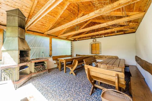 a living room with a table and a fireplace at Apartmány U Žaloudků in Dolní Morava
