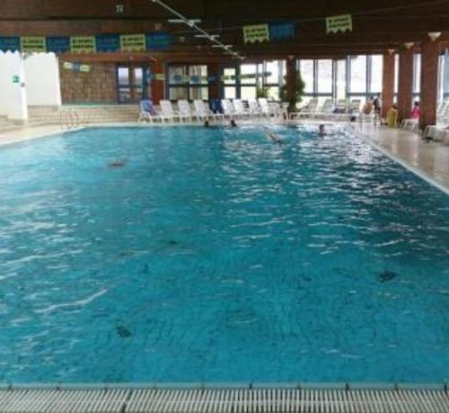 a large pool of blue water in a building at Residence kurtz in Maso Corto