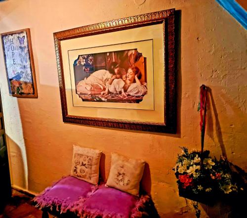 a picture hanging on a wall with a couch at La Ronda in Cuenca