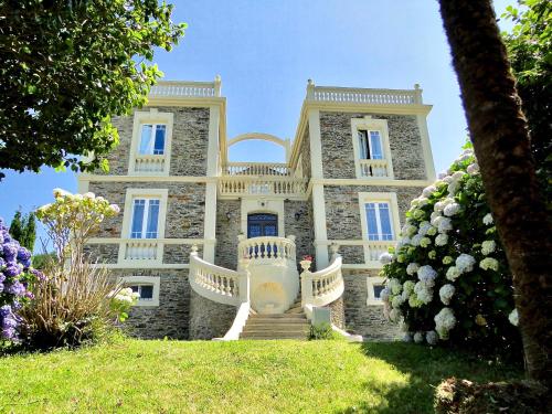 a large stone house with stairs in front of it at Villa Auristela in Navia