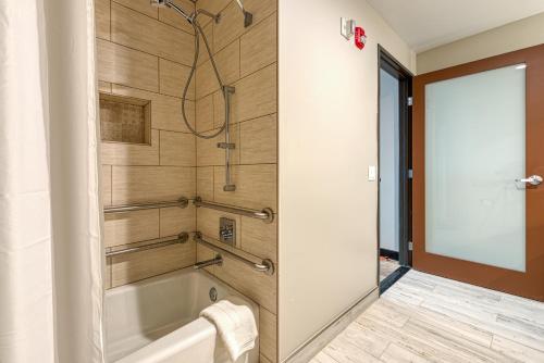 a bathroom with a tub and a shower stall at Hotel Lexen Newhall & Santa Clarita - Near Six Flags Magic Mountain in Santa Clarita
