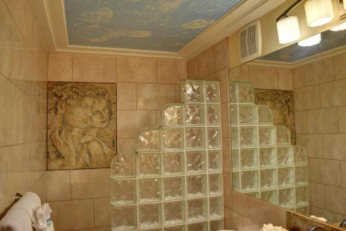 a bathroom with a shower with glass block walls at Hale Kai O'Kihei 302 in Kihei