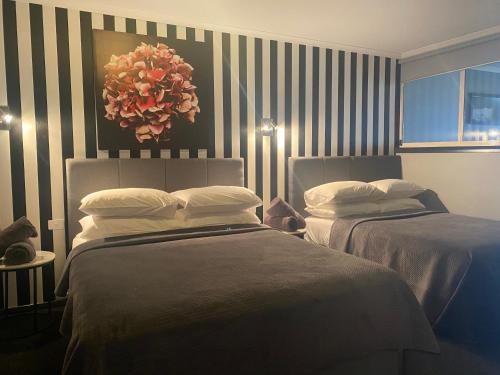 a bed room with two lamps and a large window at Waterside Holiday Rentals Unit 31 in Mulwala
