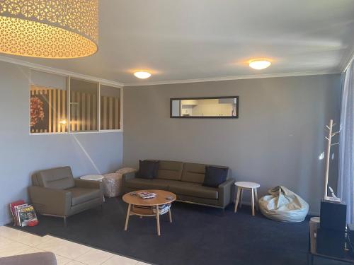 a living room with a couch and a table at Waterside Holiday Rentals Unit 31 in Mulwala