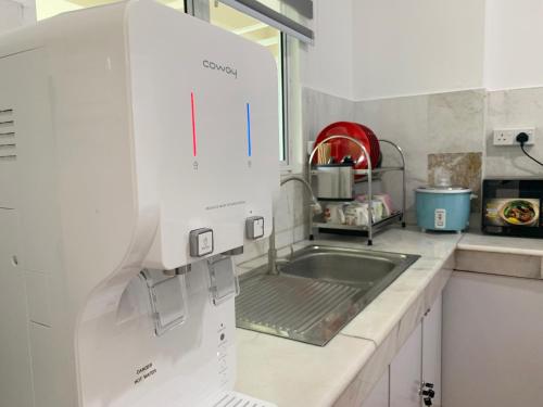 a kitchen with a sink and a counter top at Century Suria Aparment Langkawi by Zervin in Kuah