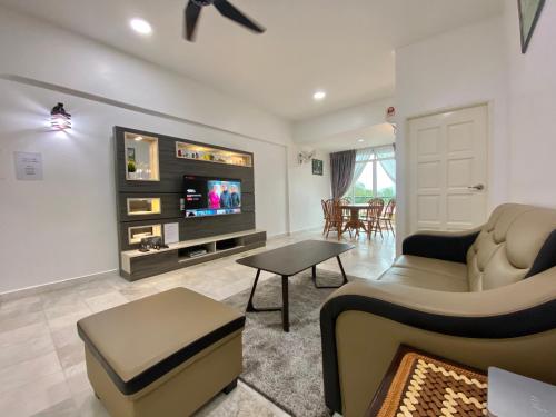 a living room with a couch and a tv at Century Suria Aparment Langkawi by Zervin in Kuah