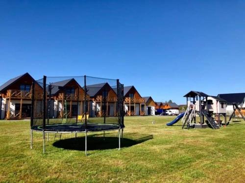 un parque con parque infantil con columpio y tobogán en SŁONECZNE TARASY, en Gąski