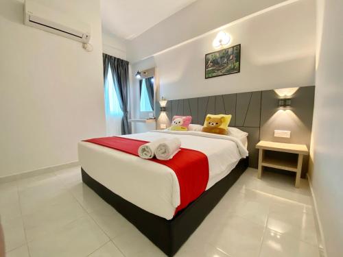 a bedroom with a large bed with towels on it at Century Suria Aparment Langkawi by Zervin in Kuah