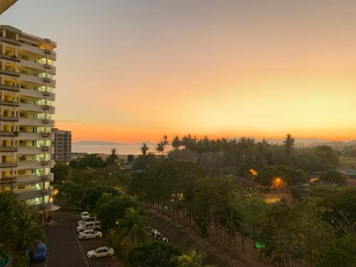 a sunset view of a city with a building at Century Suria Aparment Langkawi by Zervin in Kuah
