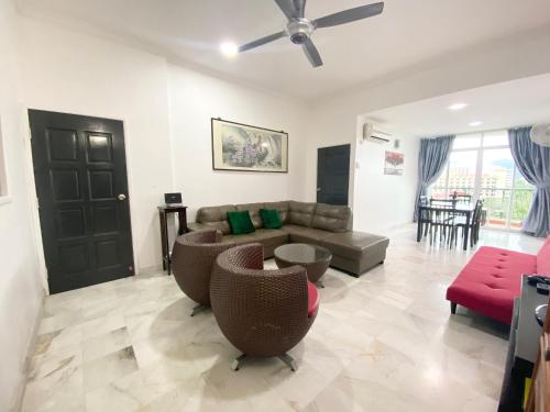 a large living room with a couch and chairs at Century Suria Aparment Langkawi by Zervin in Kuah