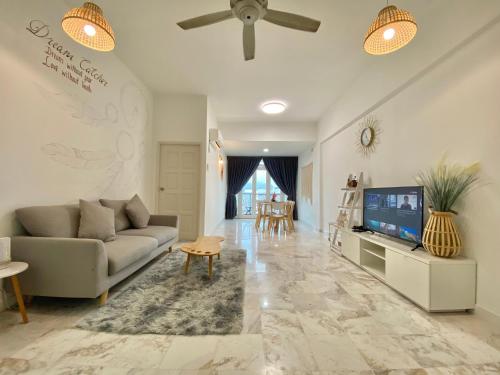 a living room with a couch and a tv at Century Suria Aparment Langkawi by Zervin in Kuah