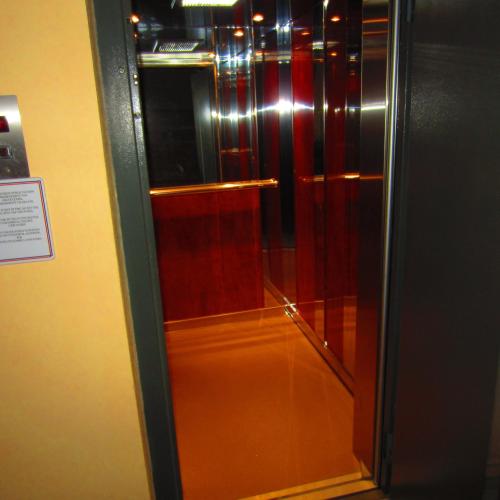 a glass door of a elevator in a building at Saint Catherine Hotel in Pythagoreio