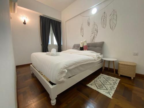 a bedroom with a white bed and a window at Century Suria Aparment Langkawi by Zervin in Kuah