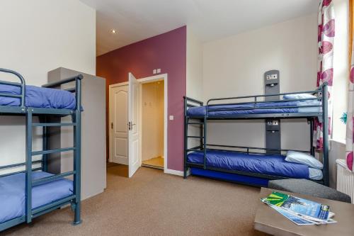 a room with three bunk beds and a hallway at Cote Ghyll Mill at Osmotherley in Osmotherley