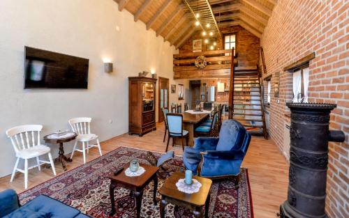 ein Wohnzimmer mit Stühlen und einer Ziegelwand in der Unterkunft Vila Countryhouse Pijevci in Novi Marof
