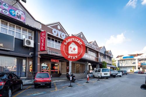 a street with cars parked in front of buildings at I Harmony Hotel in Johor Bahru