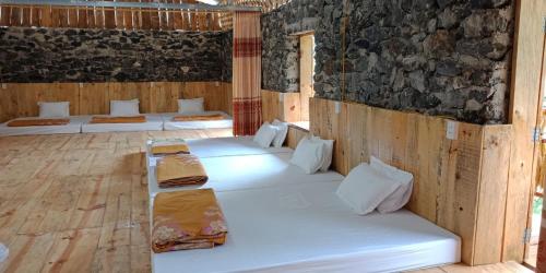 a room with several beds in it at Yen Nhi Homestay Ban Gioc in Cao Bằng