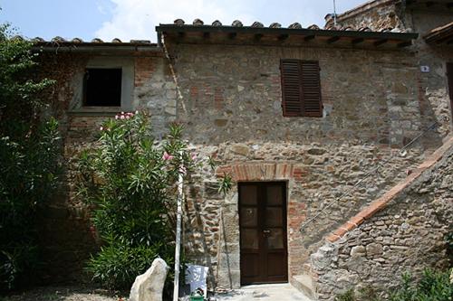 a stone building with a door in front of it at Borgo Carpineto in Vagliagli