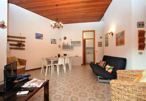 a living room with a couch and a table at Villa Ralph in Lignano Sabbiadoro