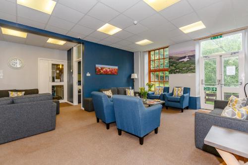 a living room with couches and a table and chairs at Cote Ghyll Mill at Osmotherley in Osmotherley
