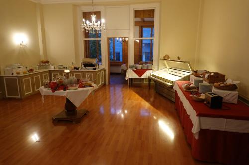 a large room with two beds and a table at Hotel Schweizerhof in Engelberg