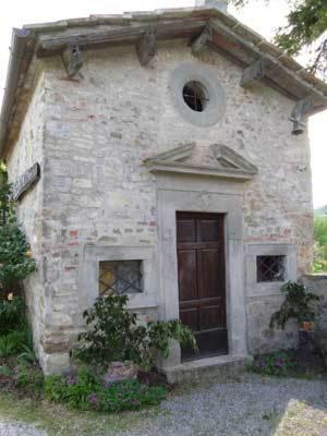 a small stone building with a door and a window at Borgo Carpineto in Vagliagli